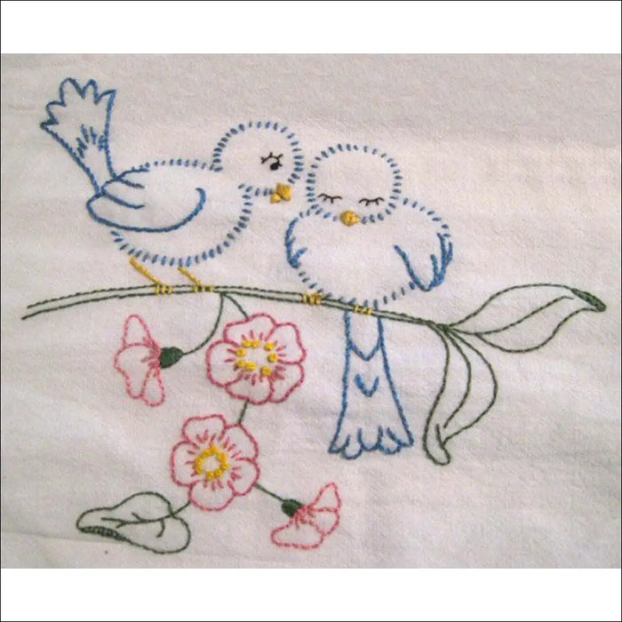 Hand-embroidered blue birds on a flowering branch from Aunt Martha’s Love in Bloom collection