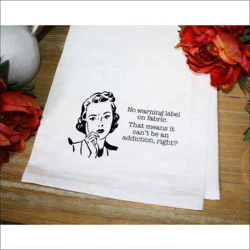 White tea towel featuring retro illustration and humorous washing label text from Aunt Martha’s Dirty Laundry