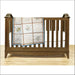 Wooden baby crib adorned with Aunt Martha’s Quilting Fabric in Multi Stripe Print